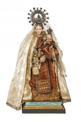 Lote 1427: "Virgen del Carmen", España S. XIX
Talla vestidera policromada con ojos de crista