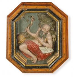 Lote 1052: Escuela Española S. XVIII
"San Jerónimo Penitente"
Alto relieve en barro policromado, montado en marco poligonal de madera con cristal.