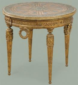 1248   -  Lote 1248: Mesa auxiliar redonda Napoleón III, estilo Luis XVI en madera tallada y dorada, con tapa de estuco, con decoración pintada con motivos clásicos.
Francia, segunda mitad S. XIX