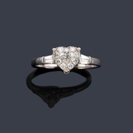 Lote 2412: YANES
Anillo con diamante central talla corazón con orla de brillantes en montura de oro blanco de 18K.