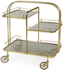 Lote 1292: Carro camarera con estructura de metal tubular dorado sobre ruedas y baldas de cristal  ahumado.
S. XX