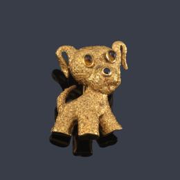 Lote 2133: Broche forma de perro con dos cuarzos citrinos y un zafiro en montura de oro amarillo de 18K efecto martelé.