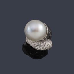 Lote 2174: LUIS GIL
Anillo con gran perla australiana de aprox. 18,44 mm con brazos contrapeados con pavé de brillantes negros e incoloros.