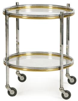 Lote 1523: Mesa circular con ruedas con estructura de metal cromado y dorado con tapa y balda de cristal.
S. XX