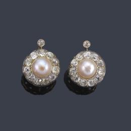 Lote 2035
Pendientes cortos con pareja de perlas de aprox. 9,23 mm y 8,89 mm con orla de diamantes talla antigua. Años '30.