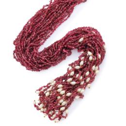 Lote 2238: Collar largo tipo corbatero con cuentas de rubíes salpicado con perlas de rio y detalles en oro amarillo de 18K.