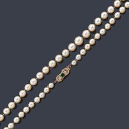 Lote 2305
Collar con un hilo de perlas de aprox. 9,50 mm a 6,00 mm con cierre en oro amarillo de 18K, esmeralda central de aprox. 0,30 ct y dos diamantes.
