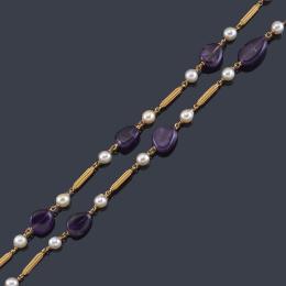 Lote 2186
Collar largo con amatistas pulidas intercalado con perlas y motivos tubulares en oro amarillo de 18K.
