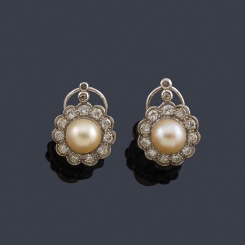  Pendientes cortos con pareja de perlas y orla de diamantes talla sencilla en montura de oro blanco de 18K.