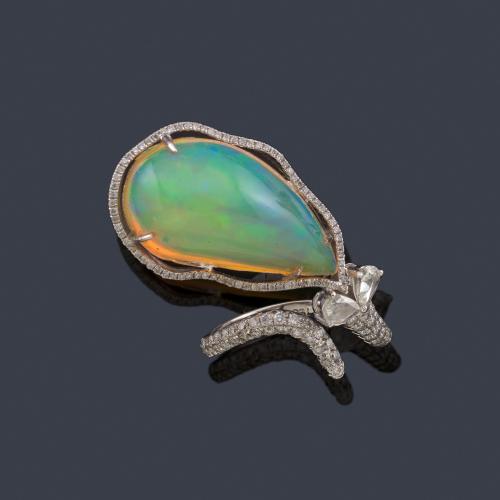 Lote 2458
Anillo con ópalo en cabujón con diamantes talla brillante y perilla de aprox. 1,16 ct en total.