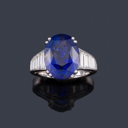 Lote 2322
Anillo con zafiro talla oval de aprox. 10,60 ct con banda de diamantes talla baguette de aprox. 1,00 ct en total. Certificado IGE.