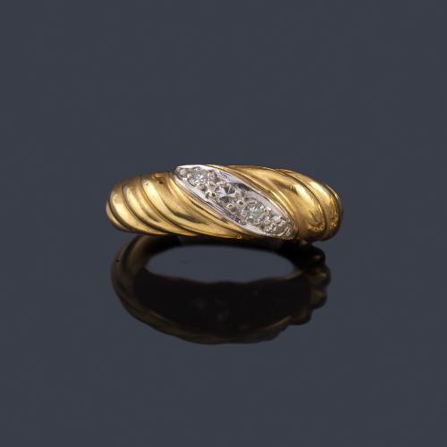  Anillo en montura de oro amarillo de 18K gallonada con banda central de diamantes.