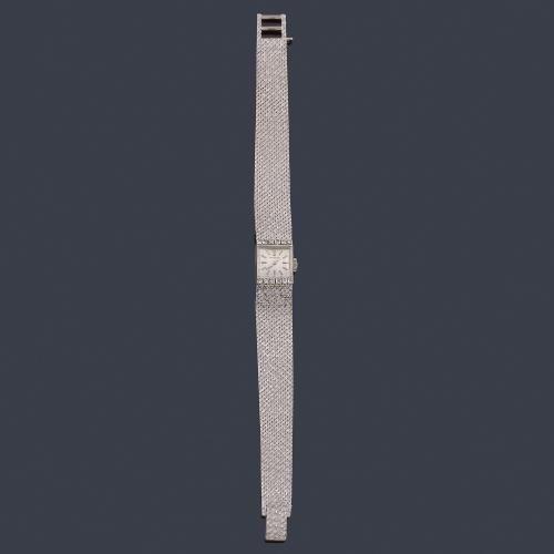  UNIVERSAL de señora con caja y brazalete en oro blanco de 18 K con brillantes.