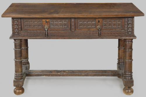 Lote 1443
Mesa bufete con tablero rectangular sobre dos cajones al frente en madera de nogal tallada y montantes torneados unidos por chambranas rectas en "H".
España, S. XVII