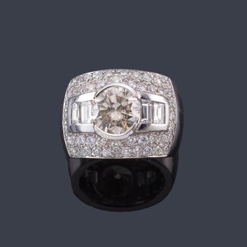 Lote 2364
Anillo ancho con brillante central de aprox. 2,76 ct con banda de diamantes talla baguette en ambos lados y pavé de brillantes.