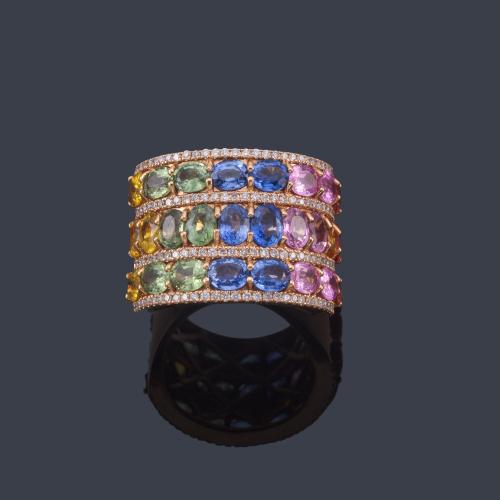 Lote 2348
Anillo con tres bandas de zafiros multicolor talla oval de aprox. 8,33 ct en total intercalado con banda de brillantes de aprox. 0,56 ct.