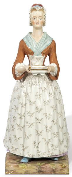 Lote 1205
La "Chica del Chocolate" escultura en porcelana pintada y esmaltada de Meissen. Espadas cruzadas en azul vidriado. Número de modelo grabado V 86.
