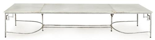  Mesa de comedor con tapa de mármol blanco sobre estructura imitando bambú en metal pintado de gris.