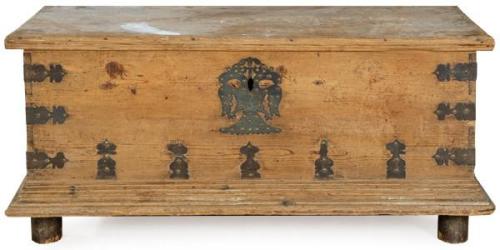  Arca en madera de pino, de estructura rectangular, con tapa y friso moldurado, con escudo de cerradura y cantoneras en hierro recortado.