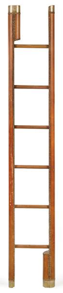  Escalera de biblioteca plegable, cuando está cerrada tiene forma de cilíndrica forrada de cuero marrón tachonado y latón.