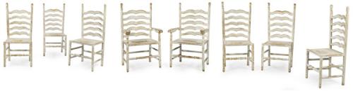  Conjunto de seis sillas y dos butacas en madera recortada, torneada y pintada de blanco.
