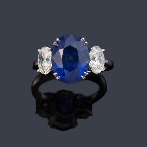 Anillo con zafiro talla oval de aprox. 6,63 ct con dos diamantes talla oval de aprox. 1,40 ct en total.