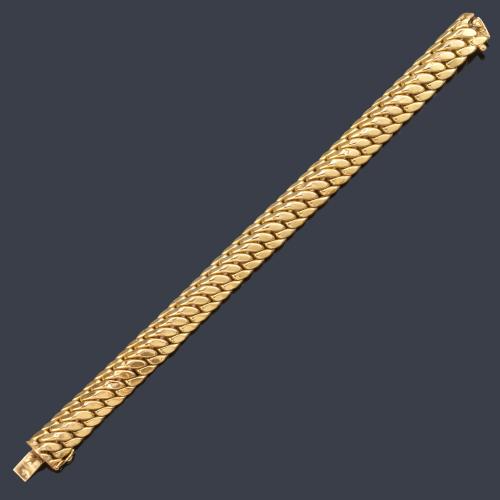 Pulsera con diseño trenzado en montura de oro amarillo de 18K.