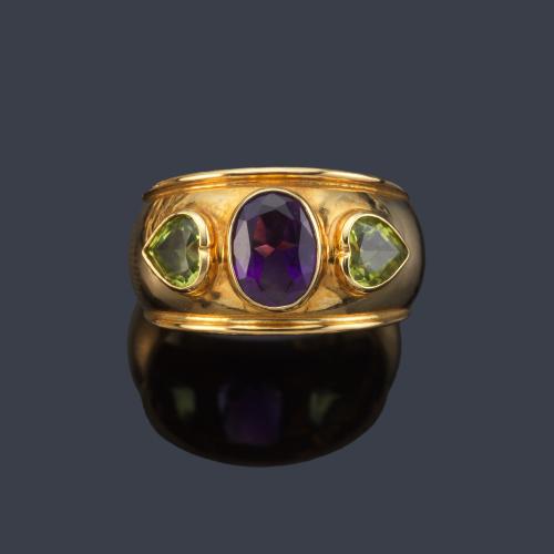 Anillo con amatista talla oval y dos peridotos talla corazón en montura de oro amarillo de 18K.