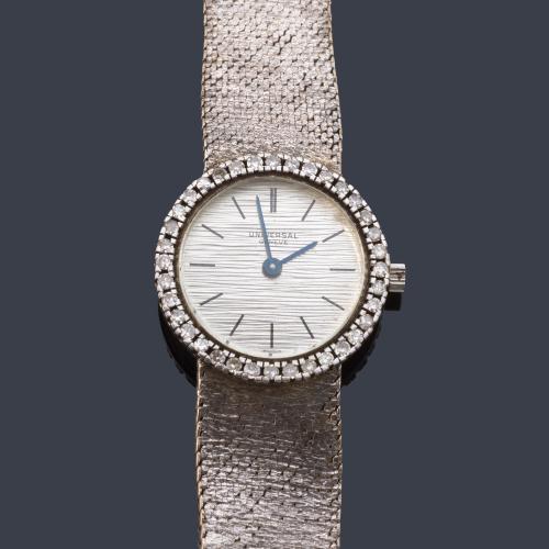 Universal Genève de señora con caja y brazalete en oro blanco de 18 K con orla de brillantes.