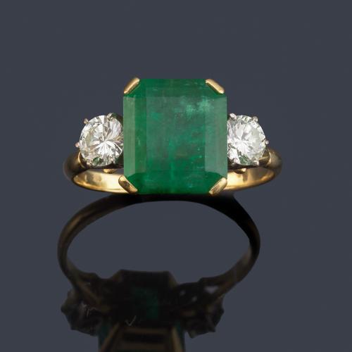 Anillo con esmeralda central de aprox. 4,10 ct con dos brillantes de aprox. 0,35 ct cada uno.