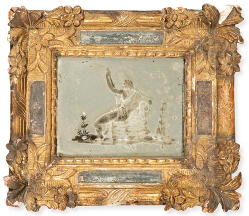 Espejo, con figura mitológica grabada, con marco en madera tallada y dorada con flores y hojas y entrecalles de espejo.