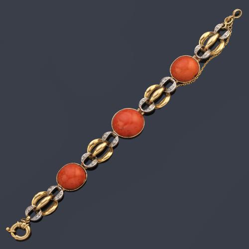 Pulsera con tres cabujones de coral engastados en bisel con eslabones en oro blanco y amarillo de 18K, enriquecidos con brillantes.