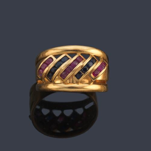 Anillo con bandas de rubíes y zafiros calibrados en montura de oro amarillo de 18K.