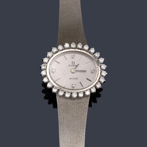 OMEGA De Ville de señora con caja y brazalete en oro blanco de 18 y orla de brillantes.