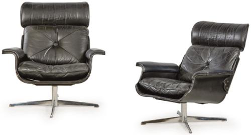 Pareja de sillones con estructura envolvente de madera laminada y moldeada revestida en cuero negro