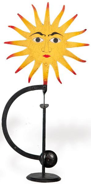 Tentetieso de hierro pintado en forma de sol con ojos móviles.
