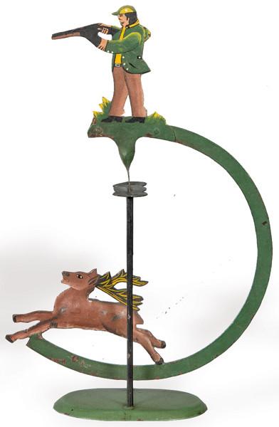 Tentetieso de hierro pintado en forma de cazador y ciervo.