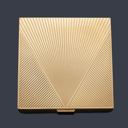 Polvera en oro amarillo de 14 K con decoración rayada.