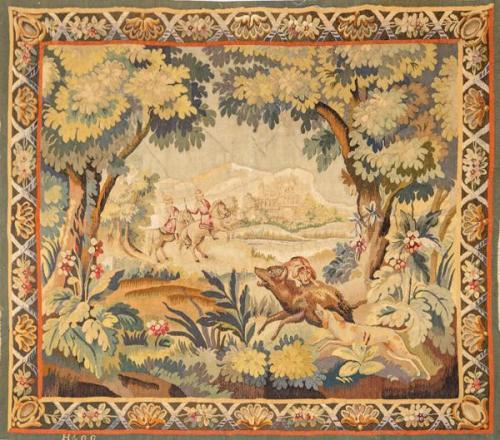  Tapiz Aubusson Verdure tejido en lana y seda, en el que se representa una escena de caza enmarcado en una cenefa con cintas y motivos vegetales. Firmado H&GG. Francia, S. XVIII