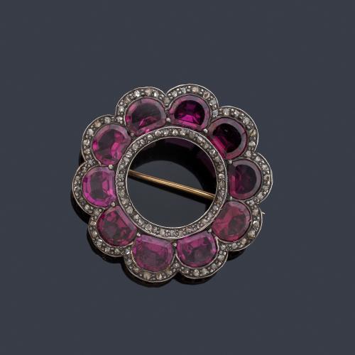 Broche circular con rubelitas talladas con orla de diamantes talla rosa. S. XIX.