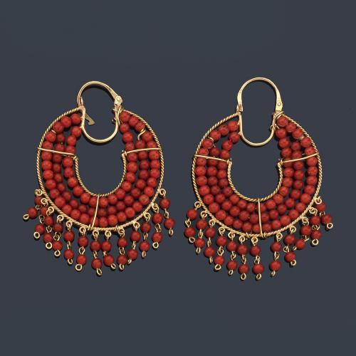 Pendientes de aro con tres filas de cuentas de coral y remates, en montura de oro amarillo de 18K.