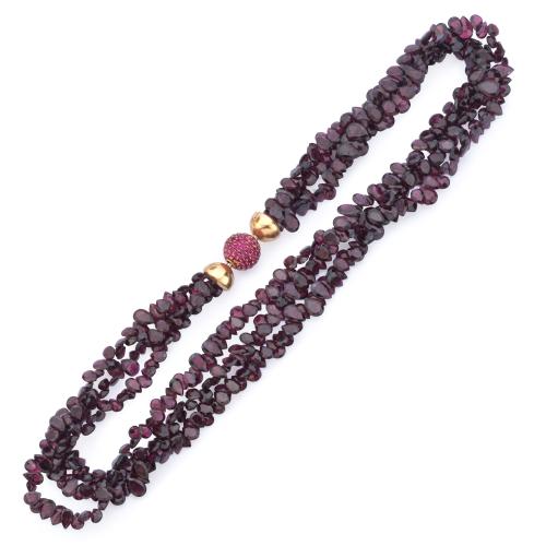 Collar con tres hilos de amatistas facetadas en diferentes longitudes con cierre esférico cuajado de rubíes en montura de oro amarillo de 18K