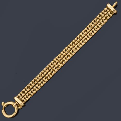 Pulsera con dos cadenas de eslabón barbado unidos con cierre marinero, en oro amarillo de 18K.