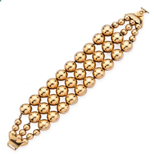 Pulsera ancha con tres bandas con motivos esféricos en oro amarillo de 18K.