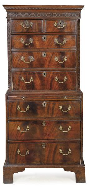 Chest on chest Chippendale en madera de caoba y palma de caoba, con dos cajones cortos sobre otros 6 largos de altura creciente, con cornisa tallada y tiradores de bornce. Superficie extraible para escribir. Inglaterra, mediados S. XVIII