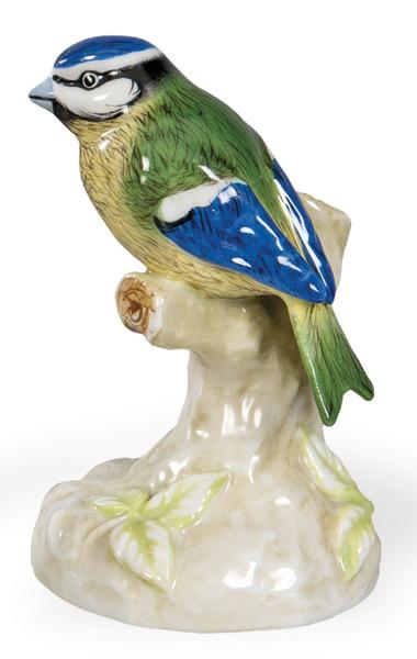  Figura de ave en porcelana policromada de Vista Alegre, Portugal, segunda mitad del siglo XX. Modelada con atención naturalista y decorada bajo cubierta en tonos azules, verdes y amarillos, presenta base vegetal integrada. Marca “VA Portugal” en la base.