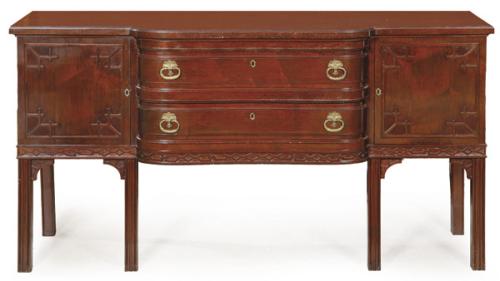 Aparador estilo Regencia, siguiendo modelos Chippendale en madera de caoba, con puertas abatibles a los lados flanqueando un cuerpo central ligeramente curvo y adelantado con dos cajones. Tiradores de bronce. S. XX