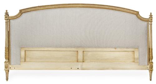  Cabecero de cama estilo Luis XVI en madera tallada, policromada y parcialmente dorada. Con el frente tapizado en tela de rayas. Con piecero y estructura de largueros.