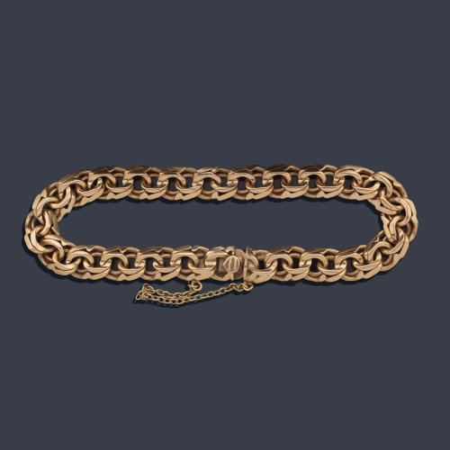  Pulsera con doble eslabón barbado en oro amarillo de 18K.