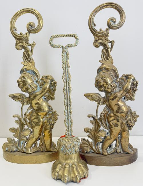 Conjunto de dos sujetapuertas de bronce en forma de amorcillos y uno en forma de garra. pp. S. XX.